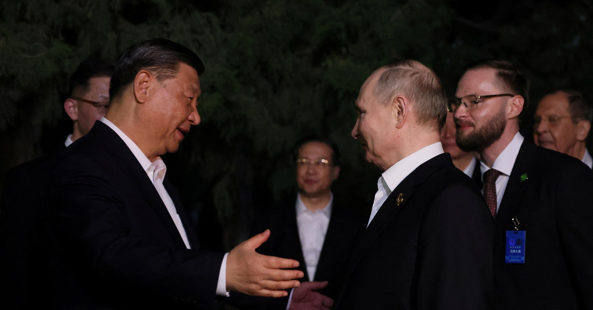 Hugs but not the full socialist-era kiss for Putin, Xi in Beijing - Reuters